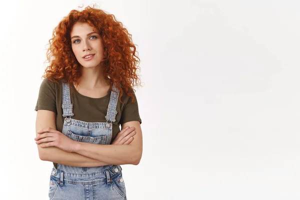 Confident empowered good-looking redhead curly-haired girl, cross arms and smiling self-assured at camera, know her work, giving professional vibes, standing ambitious, determined win