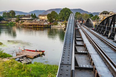 Thailand-January 31 2025:A peaceful river scene next to the famous World War 2 landmark,part of the infamous Thai-Burma 'death' Railway,now a popular tourist attraction.