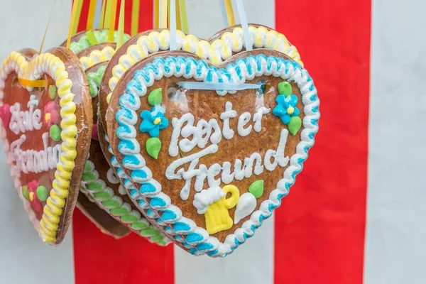 Gingerbread hearts at a folk festival with German words  best friend, Germany