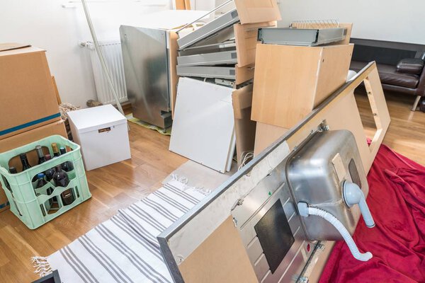 Kitchen laid out in the living room, disassembled into individual parts