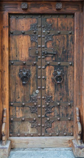 Old historical wooden door with heavy iron fittings, Germany