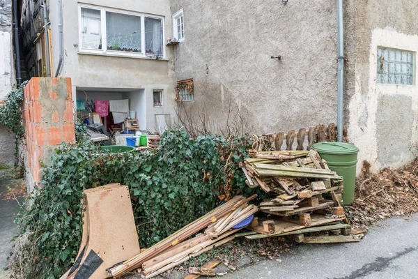 A derelict social housing in a social hotspot with garbage in the garden, Germany