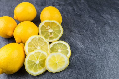 Whole lemons and sliced on a kitchen worktop