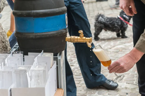A glass of beer is tapped from a barrel of home-brewed beer, Germany