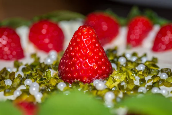 Close-up of a strawberry cream cake garnished with fresh strawberries, Germany