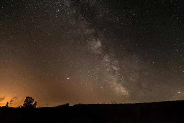 Зоряне Небо Галактикою Молочний Шлях Влітку Деревом Перед Освітленим Містом — стокове фото