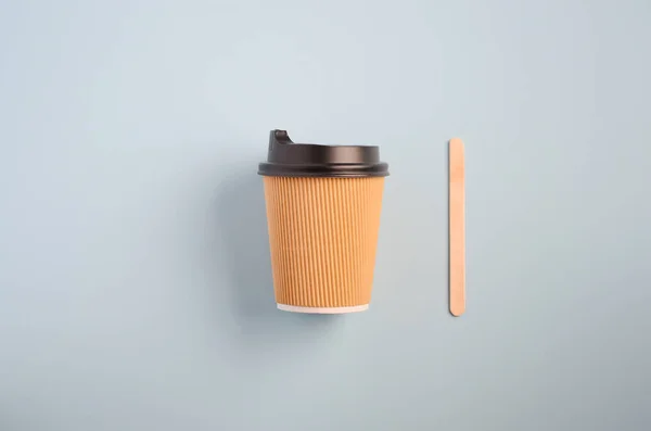 Take away coffee on blue background, top view, flat lay, copy space.
