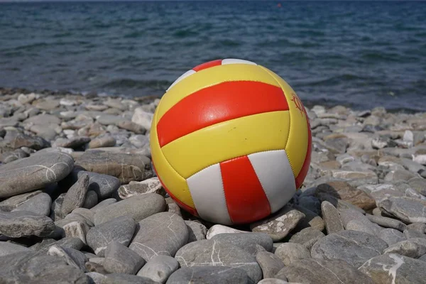 Beach volley ball on a stone beach