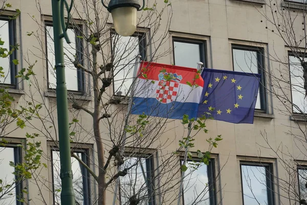 Croatian and European Union flags fluttering, outdoors