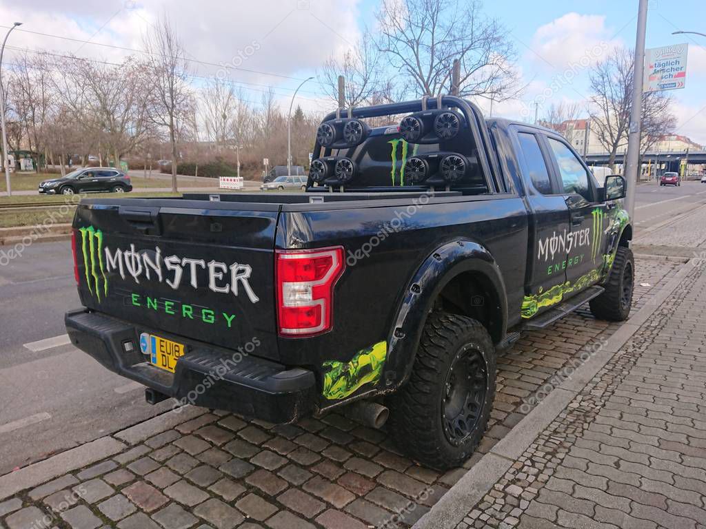 Berlin, Germany - February 12, 2019: Off road vehicle full of Monster Energy advertising labels, outdoors. Monster Energy is an energy drink known for supporting many extreme sports events