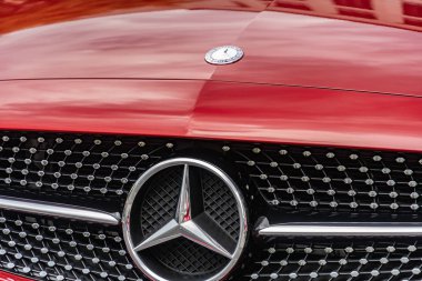 Berlin, Germany - August 25, 2018: Front view of a red Mercedes - Benz car. Mercedes Benz is a German global automobile manufacturer known for luxury vehicles, buses, coaches and trucks clipart