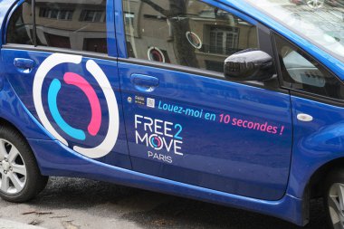 Paris, France - March 18, 2019: Free2Move Paris advertisement. Groupe PSA launched a carsharing service providing access to a fleet of 550 electric Peugeot i0n and Citron C-Zro vehicles clipart