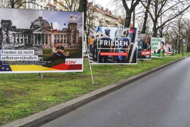 Berlin, Germany - April 14, 2019: Election campaign posters of CDU, SPD, die Linke and Alliance 90 / The Greens, German political parties for the European Parliament elections in May clipart