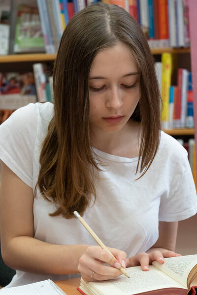 Student doing her homework in the school library