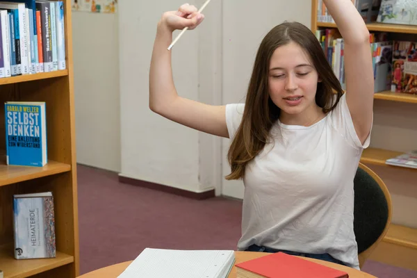 Tired Teenage Girl Stretching Herself Studying School Library — Stock Photo, Image