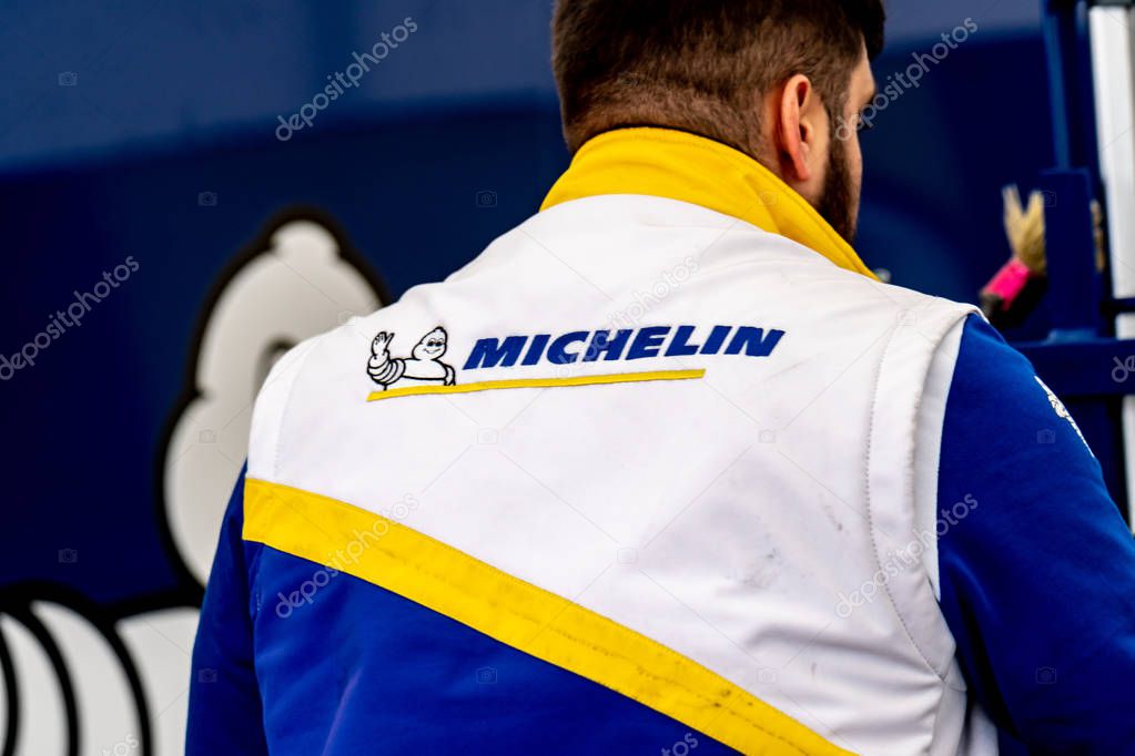 Berlin, Germany - May 25, 2019: Unrecognizable back turned Michelin mechanic. The French company Michelin is one of the three largest tire manufacturers in the world