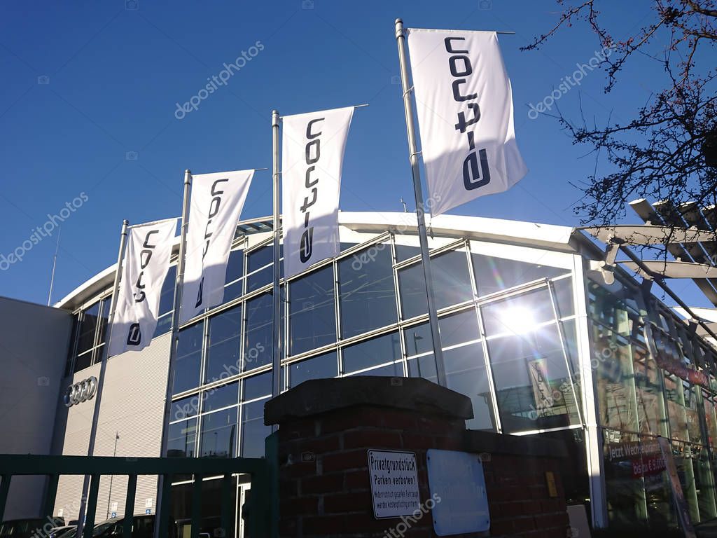 Berlin, Germany - February 24, 2019: E-tron flags outside an Audi car dealership. The Audi e-tron family is a series of electric and hybrid concept cars shown by Audi from 2009 onwards