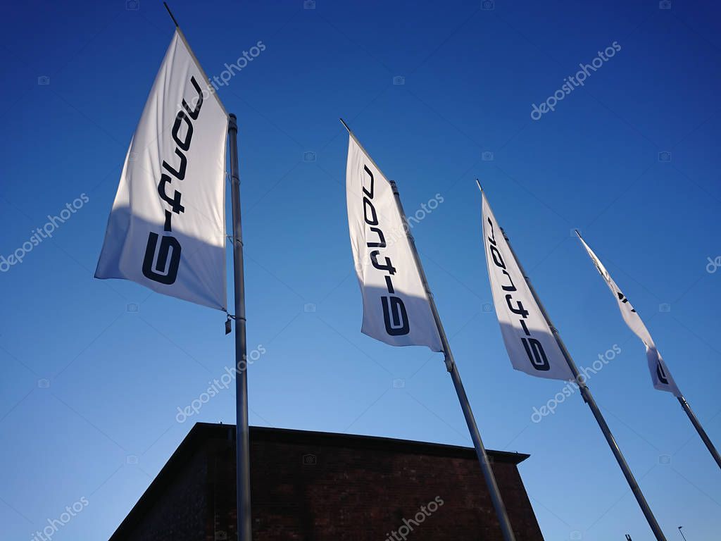 Berlin, Germany - February 24, 2019: E-tron flags outside an Audi car dealership. The Audi e-tron family is a series of electric and hybrid concept cars shown by Audi from 2009 onwards