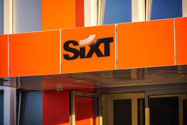 Berlin, Almanya - 22 Haziran 2019: Sixt araç kiralama şirketi şubesinin tabelası. 1912 yılında kurulan Sixt Se, 100'den fazla ülkede yaklaşık 2.000 şubesi bulunan çok uluslu bir Avrupa araç kiralama şirketidir.