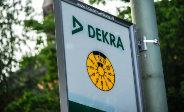 Berlin, Almanya - 22 Haziran 2019: Avrupa araç muayene şirketi Dekra'nın reklam tabelası, Almanya'nın en büyük ve dünyanın üçüncü büyük denetim şirketi