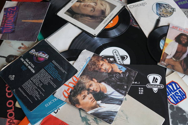 Rome, Italy - August 8, 2018: Collection of old vinyl records with sleeves. 80s greatest hits