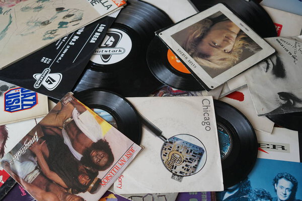 Rome, Italy - August 8, 2018: Collection of old vinyl records with sleeves. 80s greatest hits