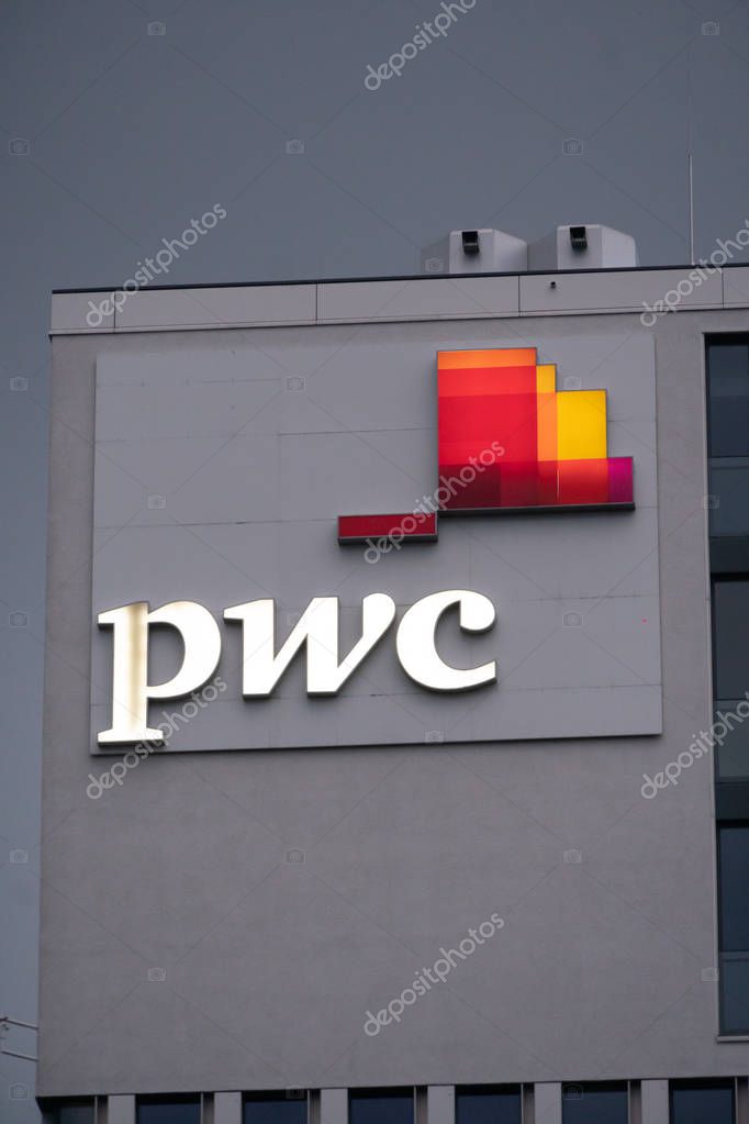 Munich, Germany - July 13, 2019: PwC signage on the top a building. PricewaterhouseCoopers is a multinational professional services network, the second largest professional services firm in the world