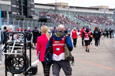 Berlin, Germany - May 25, 2019: Back turned FIA Formula E Championship host broadcaster journalists clipart