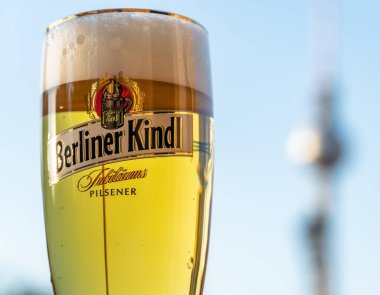 Berlin, Germany - April 19, 2019: Berliner Pilsner, glass of beer. Berliner Pilsner is a brand of beer produced in Berlin, by Berliner - Kindl - Schultheiss - Brauerei, a division of Radeberger Group