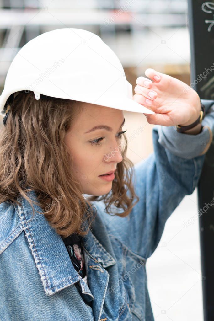 Tired female construction worker