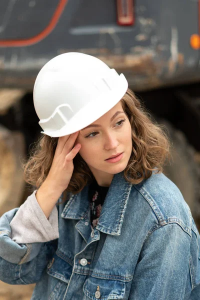 Tired factory female employee rubbing her temples dealing with an awful migraine headache