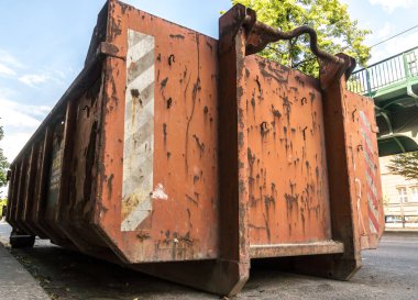 Ev çöplerini temizlemek için paslı inşaat çöplüğü.