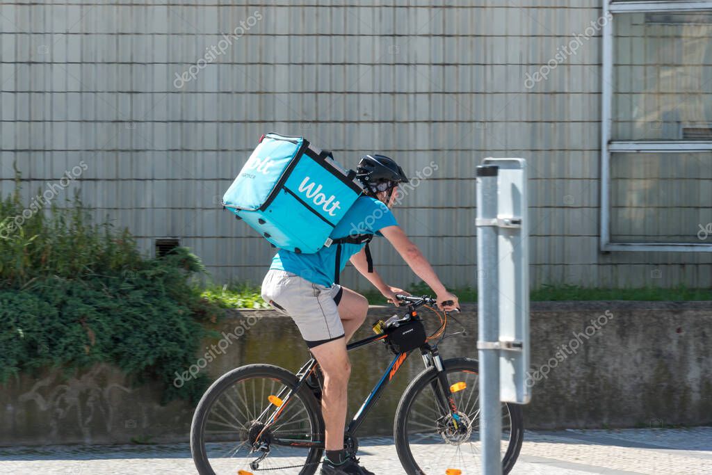Prague, Czech Republic - July 23, 2020: Wolt delivery guy at work on bike. Wolt is a Finnish technology company known for its food-delivery platform