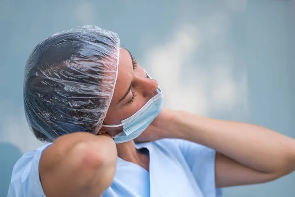 Neck muscle strain. Portrait of a tired and suffering doctor woman massaging her painful neck