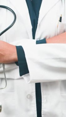 A professional medical practitioner is seen holding a stethoscope with folded arms, embodying healthcare, expertise, and reliable medical assistance. Ideal for themes of wellness, consultation, and hospital environments.