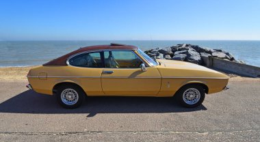 Felixstowe, Suffolk, İngiltere - 06 Mayıs 2018: Deniz kıyısındaki klasik altın 2.0 Litre Ford Capri Ghia motorlu araba park.