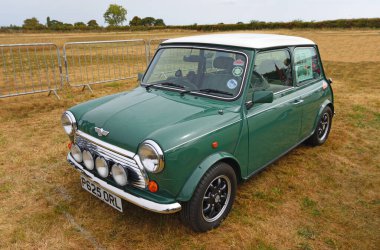 Little Gransden, Cambridgeshire, England - August 24, 2025: Classic Mini Cooper Motor Car Isolated parked on grass