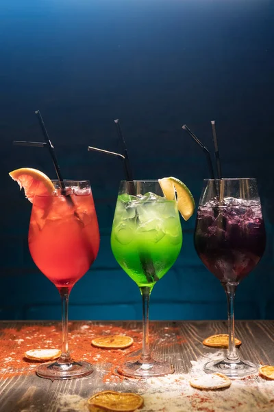 set of colorful alcohol cocktails with straws;