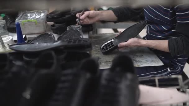 Male craftsman makes stylish footwear or repair — Stock Video