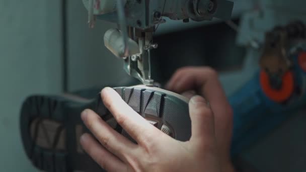 Worker sewing shoes on footwear manufacture with machinery — Stock Video