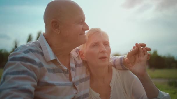 Pasangan senior yang bahagia berpelukan dan berbicara pada tanggal romantis di taman — Stok Video