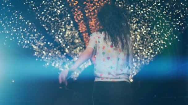 아름답고 곱슬곱슬 한 머리의 브라 운트 여인 이미소를 짓고 도시의 밤에 밝은 야외를 걷고 있다 — 비디오