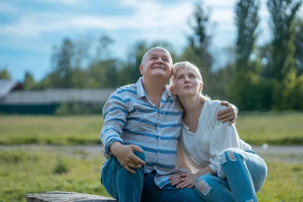 Feliz pareja de ancianos citas y abrazos y hablar en el parque en el día soleado — Foto de Stock
