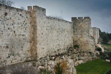 Medieval walls of Jerusalem. Ancient stone, gloomy sky. Gloomy walls of Jerusalem clipart