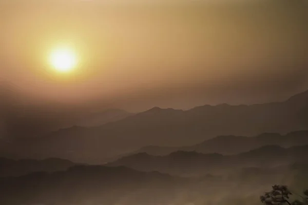 Smog in the mountains of China in the vicinity of Beijing air is saturated smog-red sunset