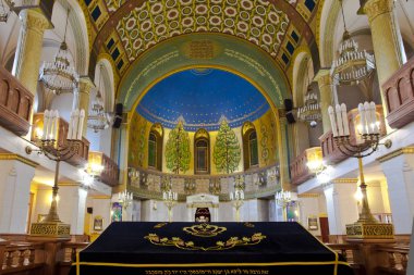 Moscow / Russia-June, 22, 2018: Intnnier of the Moscow Choral Synagogue.Elevation (chair) for reading Torah, candlesticks-menorahs clipart