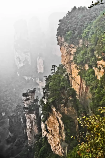Rocky cliffs among the fog, sheer cliffs. China, Zhangjiajie National Forest Park