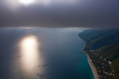bir duvar bulutlar ve onu bulutlar Güneş bulutların aşağıya doğru yumruk altında güzel bir deniz.