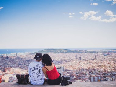 Barcelona, Spain - September 10, 2017: View of a couple watching the city of Barcelona from the Carmel's bunkers clipart