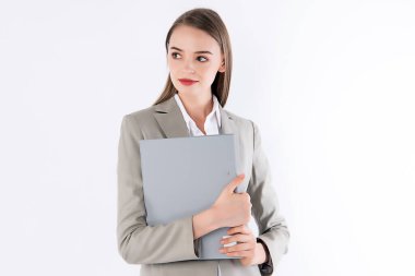 Working woman is holding her folder with smart outfit.